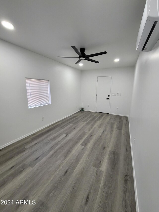 2002 W Adams St, Phoenix, AZ 85009 - unfurnished room featuring an AC wall unit, recessed lighting, wood finished floors, ceiling fan, and baseboards