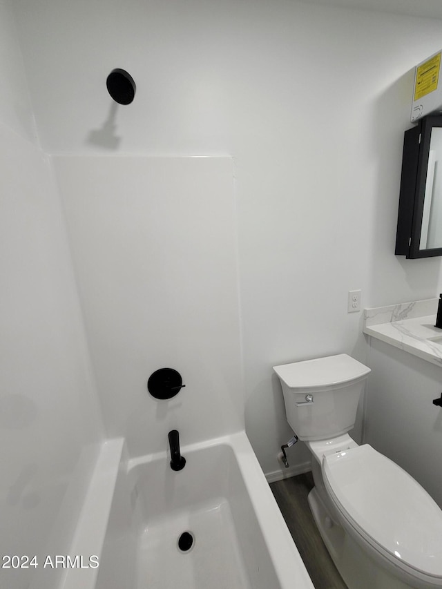 bathroom featuring wood-type flooring and toilet