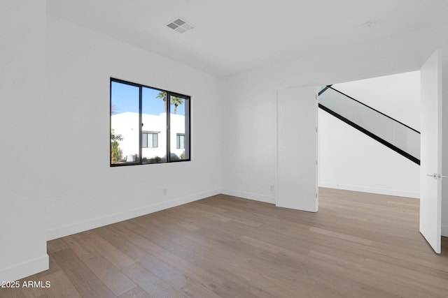 empty room with light hardwood / wood-style flooring