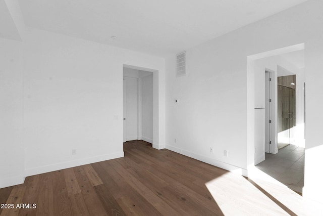 unfurnished room with dark hardwood / wood-style floors