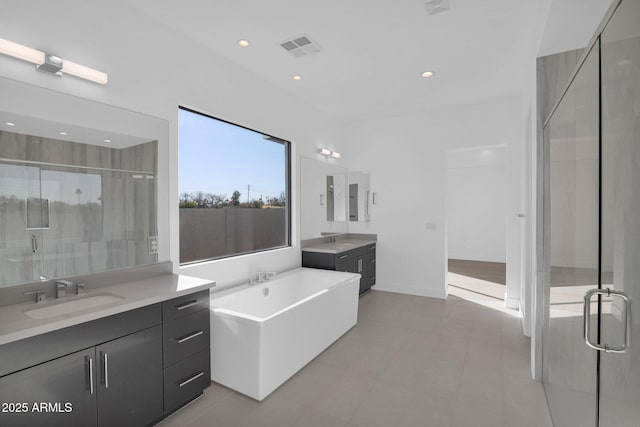 bathroom featuring tile patterned flooring, plus walk in shower, and vanity