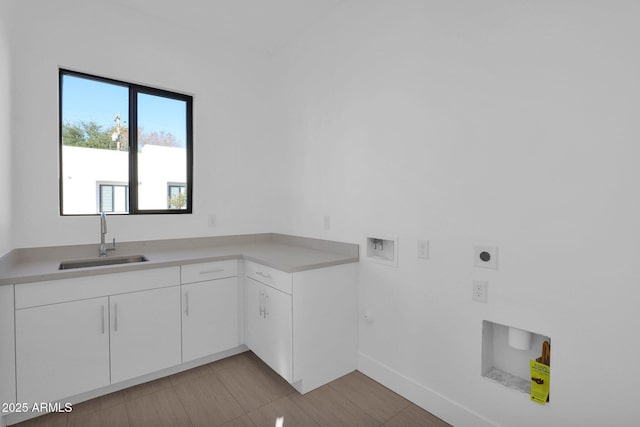 laundry area featuring hookup for a washing machine, cabinets, hookup for an electric dryer, and sink