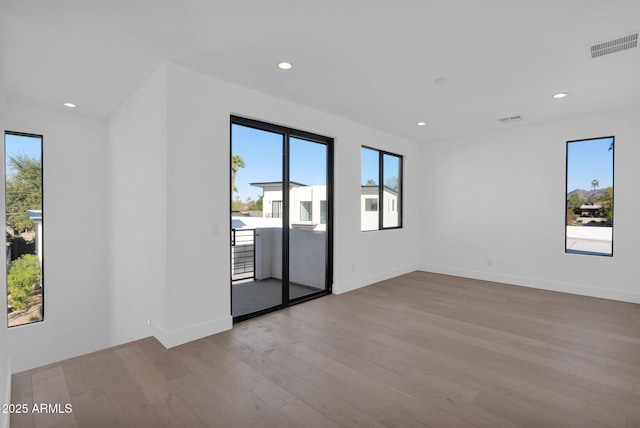 empty room featuring light hardwood / wood-style flooring and a healthy amount of sunlight