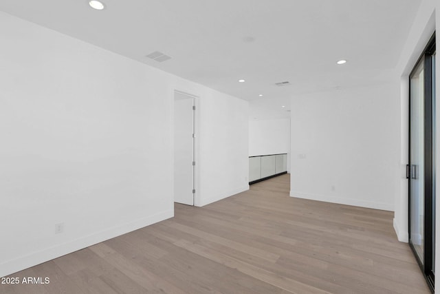 spare room featuring light hardwood / wood-style floors