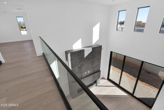 stairway with hardwood / wood-style floors and plenty of natural light