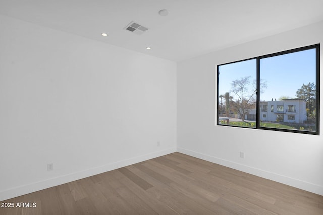 spare room with light hardwood / wood-style flooring