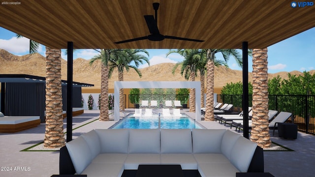 view of patio featuring an outdoor hangout area, ceiling fan, a community pool, and a mountain view