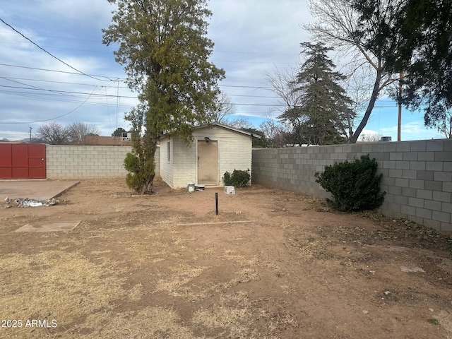 view of yard with an outbuilding and a fenced backyard