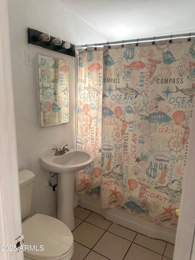 full bathroom featuring shower / bath combo with shower curtain, toilet, and tile patterned floors