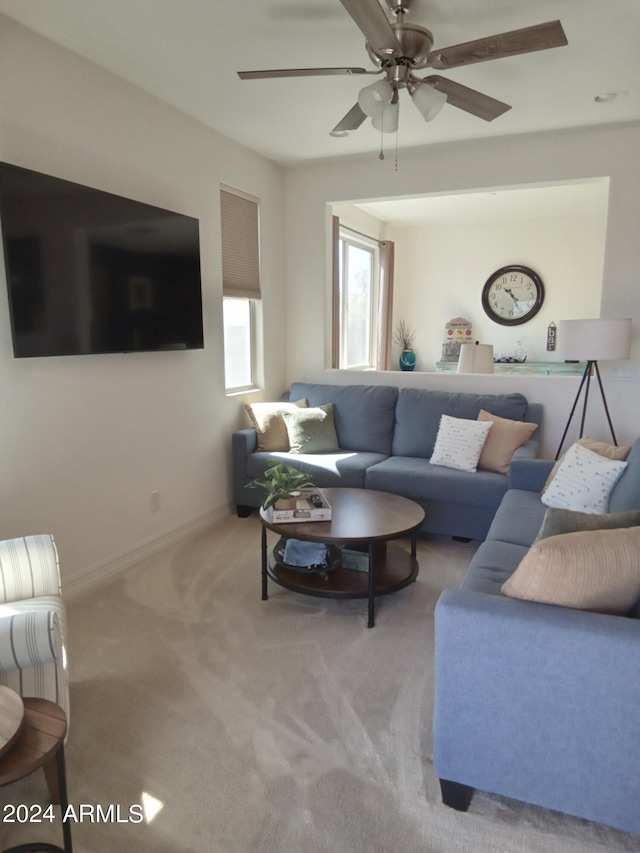 carpeted living room featuring ceiling fan