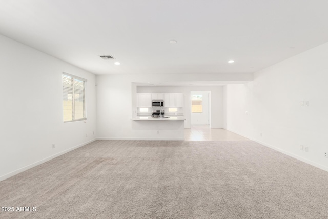 3815 S 64th Ln, Phoenix, AZ 85043 - unfurnished living room with baseboards, light carpet, and recessed lighting