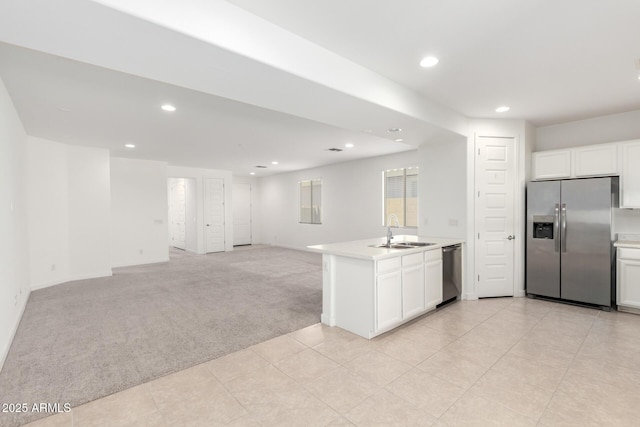 3815 S 64th Ln, Phoenix, AZ 85043 - kitchen with stainless steel appliances, light colored carpet, a sink, light countertops, and open floor plan