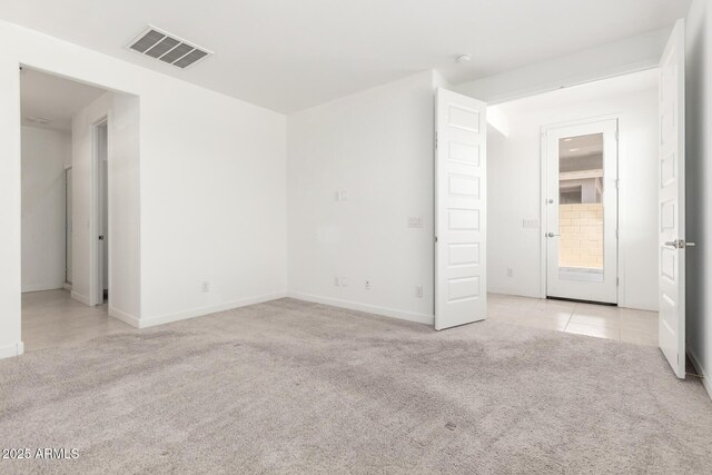3815 S 64th Ln, Phoenix, AZ 85043 - empty room with light carpet, baseboards, and light tile patterned floors