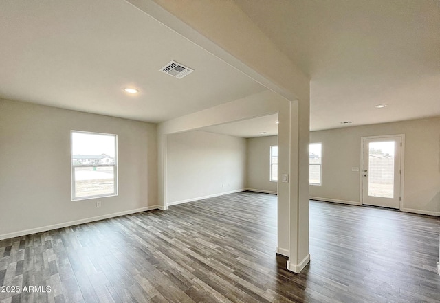 unfurnished room with recessed lighting, wood finished floors, visible vents, and baseboards