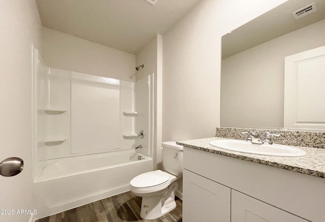 full bathroom with shower / bath combination, visible vents, toilet, vanity, and wood finished floors