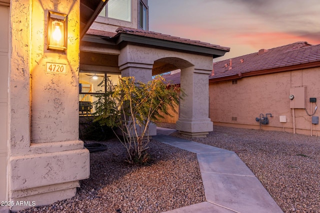 view of exterior entry at dusk