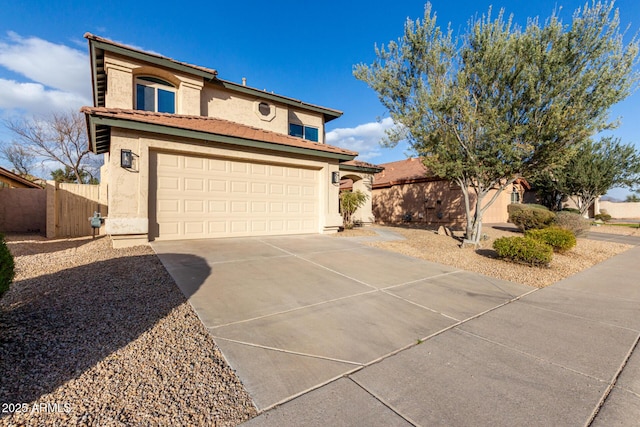 view of front of property featuring driveway, a garage, a tile roof, fence, and stucco siding