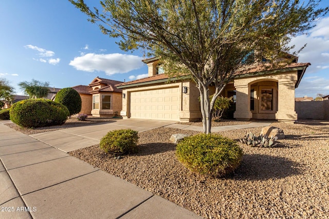 view of front of property with driveway, a tiled roof, and stucco siding