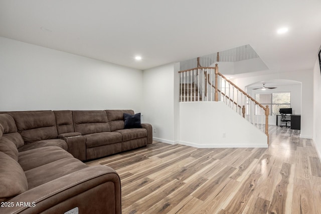 living room with recessed lighting, stairway, baseboards, and wood finished floors