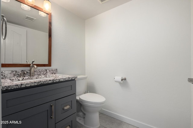 bathroom featuring visible vents, baseboards, toilet, tile patterned flooring, and vanity