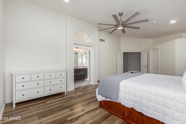 bedroom featuring lofted ceiling, recessed lighting, wood finished floors, visible vents, and baseboards