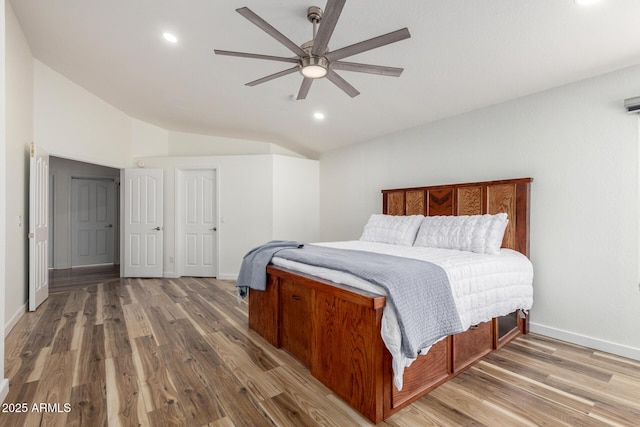 bedroom featuring lofted ceiling, ceiling fan, wood finished floors, and baseboards