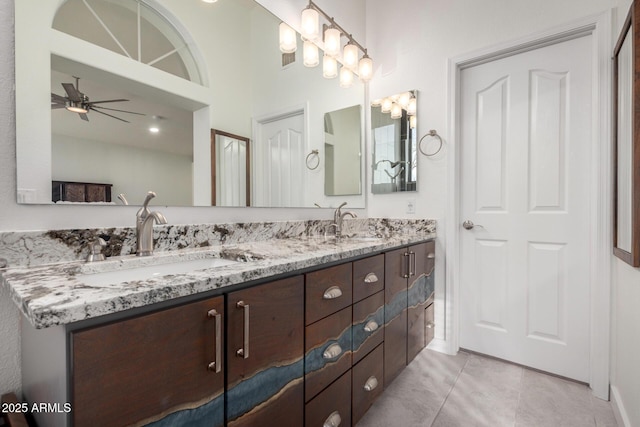 full bathroom with tile patterned flooring, double vanity, a sink, and ceiling fan