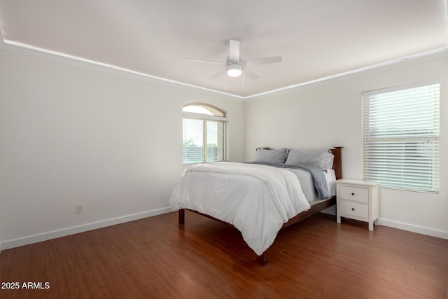 bedroom with wood finished floors and crown molding