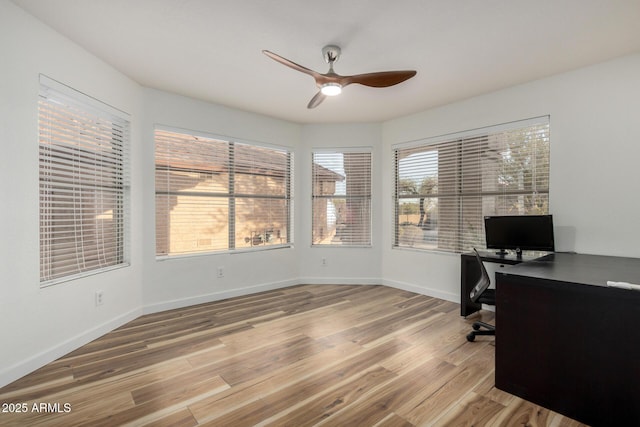 office space featuring wood finished floors, a ceiling fan, and baseboards