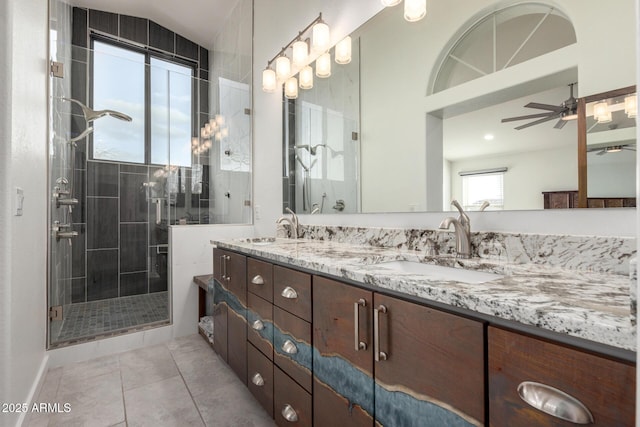 full bathroom with a shower stall, double vanity, a sink, and tile patterned floors