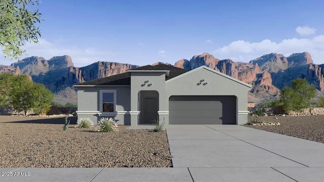 view of front facade featuring a garage and a mountain view