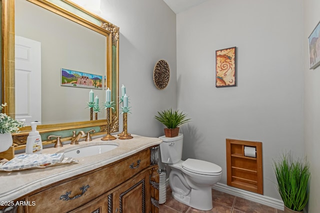 bathroom featuring tile patterned flooring, vanity, and toilet