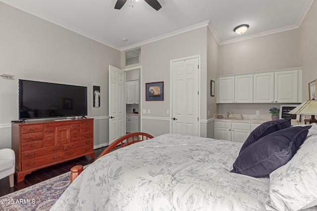 bedroom featuring ceiling fan, ornamental molding, and sink