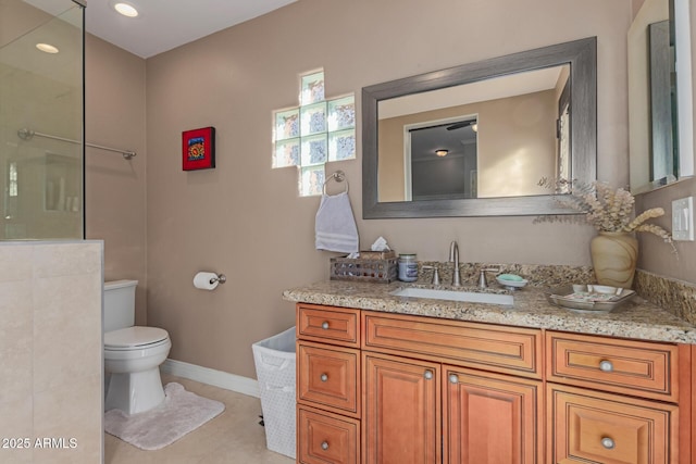 bathroom featuring vanity, tile patterned flooring, and toilet