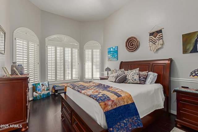 bedroom with dark wood-type flooring