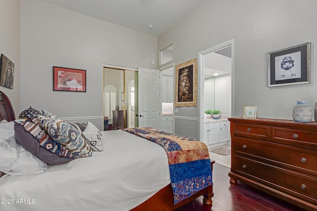 bedroom with wood-type flooring, ensuite bath, and a closet