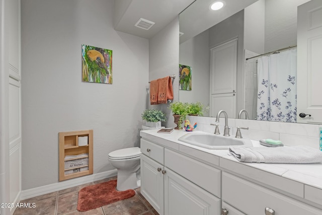 bathroom featuring vanity, tile patterned flooring, and toilet