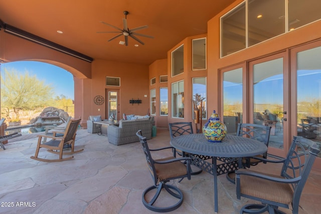 view of patio with an outdoor living space and ceiling fan