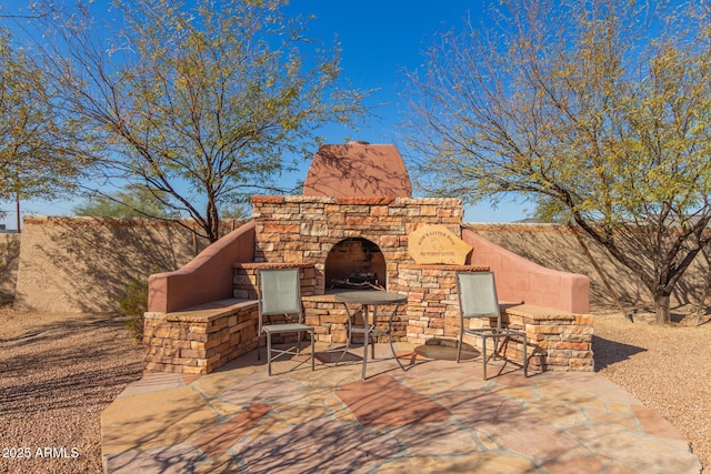 view of patio / terrace with an outdoor stone fireplace