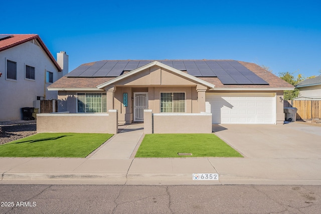 view of front of property with a garage, a front lawn, and solar panels