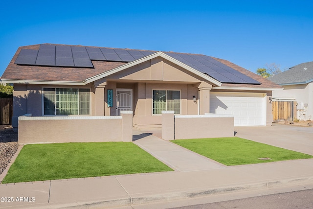 view of front of home with a garage and solar panels