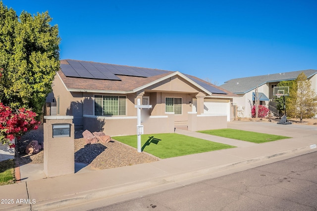 single story home with a garage and solar panels