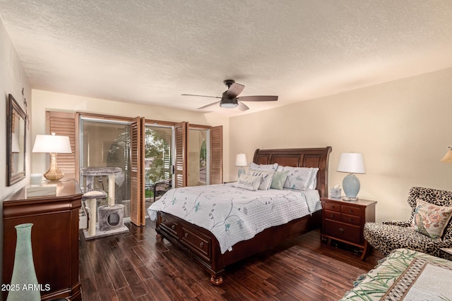 bedroom with access to outside, ceiling fan, dark hardwood / wood-style flooring, and a textured ceiling