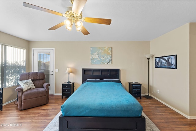 bedroom with ceiling fan, baseboards, and wood finished floors