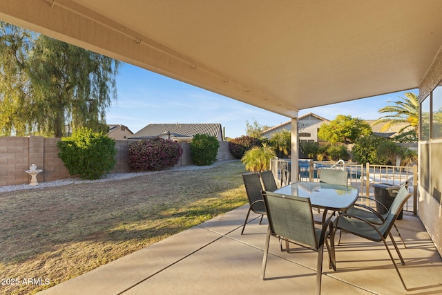 view of patio featuring a fenced backyard and outdoor dining area