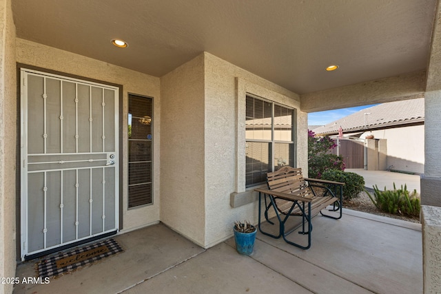 property entrance featuring stucco siding