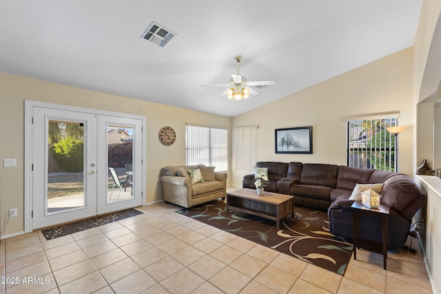 living area with french doors, light tile patterned floors, lofted ceiling, visible vents, and ceiling fan