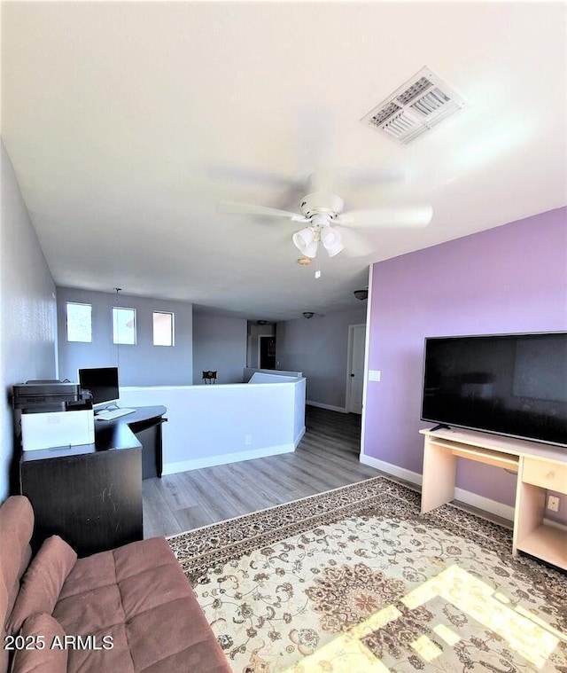 living room with ceiling fan and wood-type flooring