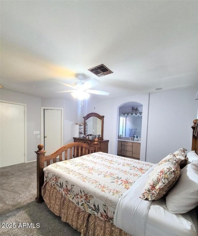 carpeted bedroom with connected bathroom and ceiling fan