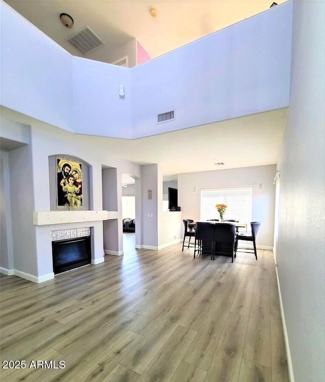 living room featuring a high ceiling and wood-type flooring